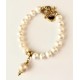 9 mm white freshwater pearl bracelet with barok pearl . Steel/gold