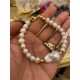 7-8 mm white freshwater pearl bracelet with big barok. Steel/gold